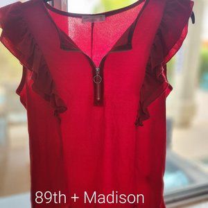 Red sleeveless blouse with front zipper